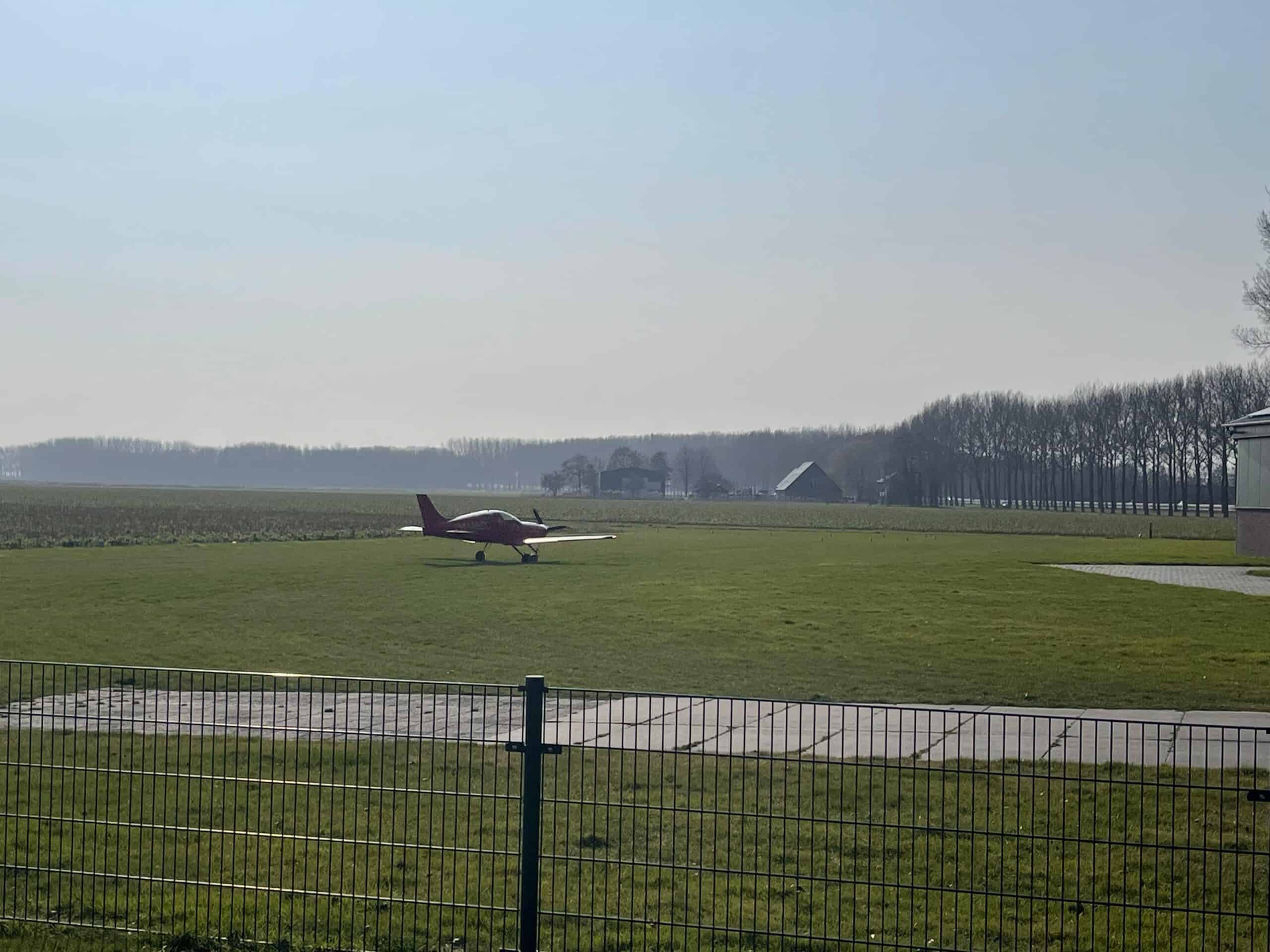 small airplane on a grass runway